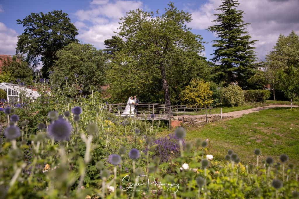 hodsock priory wedding photography bride groom on bride with flowers